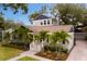 Stunning angle of the home with meticulous landscaping, lush green lawn, and a brick-paved driveway at 2933 W Alline Ave, Tampa, FL 33611