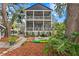 The backyard has lush landscaping and a two-story screened porch at 2933 W Alline Ave, Tampa, FL 33611
