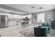 Bright, open kitchen with stainless steel appliances, an island, and an adjacent living area at 2933 W Alline Ave, Tampa, FL 33611
