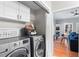 Functional laundry room with modern washer and dryer units and white cabinetry at 2933 W Alline Ave, Tampa, FL 33611