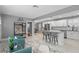 Open-concept living room and kitchen featuring modern white cabinetry and stylish decor at 2933 W Alline Ave, Tampa, FL 33611