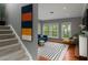 Cozy living room near staircase offers ample natural light, hardwood floors, and stylish contemporary furnishings at 2933 W Alline Ave, Tampa, FL 33611