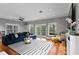 Bright and airy living room with a blue sofa, stylish rug, and modern decor at 2933 W Alline Ave, Tampa, FL 33611