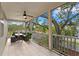 Expansive screened-in patio with outdoor seating, ceiling fan, and serene backyard views through the screen at 2933 W Alline Ave, Tampa, FL 33611