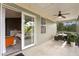 Relaxing screened patio features neutral tile, ceiling fan, and outdoor seating area at 2933 W Alline Ave, Tampa, FL 33611
