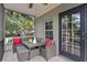 Inviting screened patio offers outdoor seating with a modern table and comfortable gray wicker furniture at 2933 W Alline Ave, Tampa, FL 33611