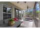 Enjoy the outdoors on this screened patio with hot tub and comfortable gray wicker seating area at 2933 W Alline Ave, Tampa, FL 33611