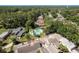 Stunning aerial view of homes showcasing lush landscaping and a sparkling community pool, perfect for relaxation and recreation at 3071 Bolt Dr, Palm Harbor, FL 34685