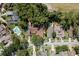 Overhead view of homes with manicured lawns and a community pool, reflecting suburban charm and appeal at 3071 Bolt Dr, Palm Harbor, FL 34685
