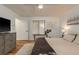 Comfortable bedroom with wood floors, a ceiling fan, and a cozy bed adorned with decorative throw blanket at 3071 Bolt Dr, Palm Harbor, FL 34685
