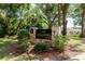 Elegant community sign for The Meadows surrounded by lush landscaping and mature trees at 3071 Bolt Dr, Palm Harbor, FL 34685