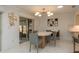 Bright dining room featuring modern light fixture, tile flooring, and sliding doors to the outdoor patio at 3071 Bolt Dr, Palm Harbor, FL 34685