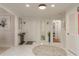 Bright foyer with white tile floors, a stylish console table, and a front door with sidelights at 3071 Bolt Dr, Palm Harbor, FL 34685