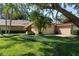 Charming home featuring well-manicured landscaping and mature trees with a two car garage at 3071 Bolt Dr, Palm Harbor, FL 34685