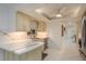 Bright kitchen features marble countertops, a modern sink, and white cabinetry with ample natural light at 3071 Bolt Dr, Palm Harbor, FL 34685