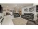 Spacious living room featuring an open floor plan with gray leather couches and tile floors at 3071 Bolt Dr, Palm Harbor, FL 34685