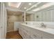 Bright main bathroom featuring dual sinks, a large mirror, and a walk-in shower, combining style and functionality at 3071 Bolt Dr, Palm Harbor, FL 34685