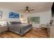 Comfortable main bedroom featuring a ceiling fan, hardwood floors, and ample natural light from the window at 3071 Bolt Dr, Palm Harbor, FL 34685