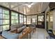 Relaxing sunroom with tile flooring, modern furniture, and plenty of natural light at 3071 Bolt Dr, Palm Harbor, FL 34685