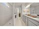 Contemporary bathroom featuring a walk-in shower and double sink vanity with granite countertop at 31643 Colada Drift Way, Wesley Chapel, FL 33545