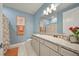 Stylish bathroom featuring blue walls, a floral shower curtain, and a granite topped vanity at 31643 Colada Drift Way, Wesley Chapel, FL 33545