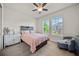 Cozy bedroom with a plush pink bed, wooden headboard, and bright windows for natural light at 31643 Colada Drift Way, Wesley Chapel, FL 33545