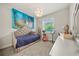 Bedroom featuring an upholstered bed, unique lighting, and a view to the backyard at 31643 Colada Drift Way, Wesley Chapel, FL 33545