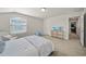 Bright bedroom with window and a television atop a wooden console table at 31643 Colada Drift Way, Wesley Chapel, FL 33545