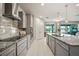 Open kitchen with granite countertops, sleek stainless steel appliances, and modern finishes seamlessly flowing to the outdoors at 31643 Colada Drift Way, Wesley Chapel, FL 33545