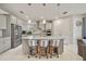 Modern kitchen with an island with seating and sleek appliances, offering a perfect blend of style and functionality at 31643 Colada Drift Way, Wesley Chapel, FL 33545