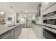Well-equipped modern kitchen with stainless steel appliances, granite countertops, and sleek cabinetry for a gourmet experience at 31643 Colada Drift Way, Wesley Chapel, FL 33545