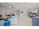 Bright open-concept space with tile floors, transitioning from the living area to kitchen and dining, perfect for modern living at 31643 Colada Drift Way, Wesley Chapel, FL 33545