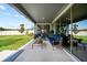 Covered patio with comfortable seating, ideal for relaxing and entertaining outdoors at 31643 Colada Drift Way, Wesley Chapel, FL 33545
