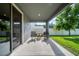 Covered patio featuring rocking chairs and a small table, perfect for enjoying the outdoors at 31643 Colada Drift Way, Wesley Chapel, FL 33545