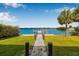 Stunning backyard with water access, a private dock, lush lawn and charming stone path, perfect for waterfront living at 321 N Boulevard Of The Presidents, Sarasota, FL 34236