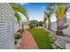Beautiful backyard featuring a brick pathway, lush landscaping, and glimpses of a refreshing pool at 321 N Boulevard Of The Presidents, Sarasota, FL 34236