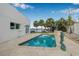 Backyard pool with travertine tile, lush landscaping, and view of the bay at 321 N Boulevard Of The Presidents, Sarasota, FL 34236