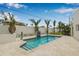 Backyard pool with travertine tile and a beautiful privacy wall lined with trees at 321 N Boulevard Of The Presidents, Sarasota, FL 34236