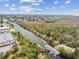 Aerial view of waterway showcases a charming neighborhood, lush foliage, and convenient boat house access at 3227 Rose Arbor Dr, Hernando Beach, FL 34607