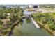 Aerial view of a boat lift and canal surrounded by lush greenery and buildings at 3227 Rose Arbor Dr, Hernando Beach, FL 34607