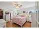 Bright bedroom with hardwood flooring, white walls, ceiling fan, and flamingo patterned bedding at 3227 Rose Arbor Dr, Hernando Beach, FL 34607