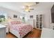 Bright bedroom with hardwood flooring, white walls, ceiling fan, and flamingo patterned bedding at 3227 Rose Arbor Dr, Hernando Beach, FL 34607