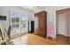 Bedroom with hardwood flooring, plantation shutters, and closet with a door at 3227 Rose Arbor Dr, Hernando Beach, FL 34607