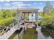Boat lift on the canal, featuring a walkway and lifting mechanism at 3227 Rose Arbor Dr, Hernando Beach, FL 34607
