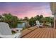 Waterfront deck offers serene views of the water, palm trees and tropical landscaping at 3227 Rose Arbor Dr, Hernando Beach, FL 34607