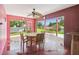 Outdoor dining area with ceiling fan featuring seating and views of the pool and canal at 3227 Rose Arbor Dr, Hernando Beach, FL 34607