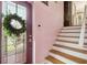 Welcoming entryway featuring a glass-paneled front door and a staircase at 3227 Rose Arbor Dr, Hernando Beach, FL 34607