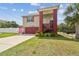 Beautiful home featuring a unique design with lush landscaping and a vibrant color scheme at 3227 Rose Arbor Dr, Hernando Beach, FL 34607