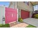 Close up of the home's exterior showcasing a colorful privacy fence and garage at 3227 Rose Arbor Dr, Hernando Beach, FL 34607