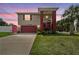 Inviting two-story home with a well-manicured front lawn, covered entryway, and two-car garage at 3227 Rose Arbor Dr, Hernando Beach, FL 34607